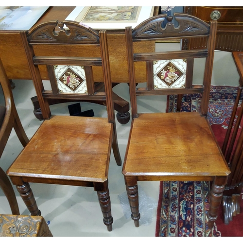 930 - A pair of late Victorian walnut aesthetic design hall chairs, inset tile backs