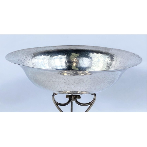675 - A hallmarked silver Arts & Crafts dish of planished circular form, raised on dome base and 3 scr... 