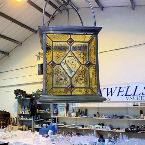 787 - A 19th century large brass hanging hall lantern with leaded glass decoration with amber coloured flo... 