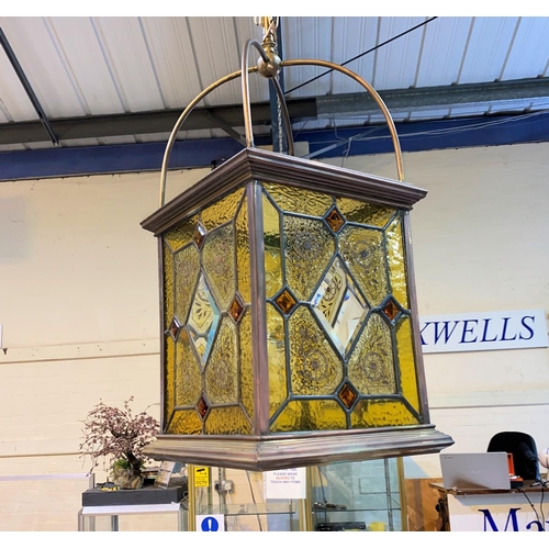 787 - A 19th century large brass hanging hall lantern with leaded glass decoration with amber coloured flo... 