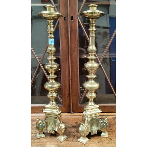 391 - A pair of large, heavy, brass candlesticks, with three feet and turned effect columns, Height 54cm.