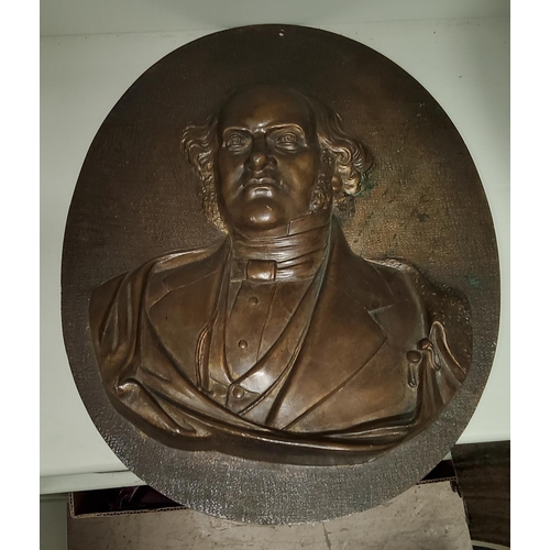 52 - A bronze relief oval plaque of a 19th century gentleman, height 34cm.