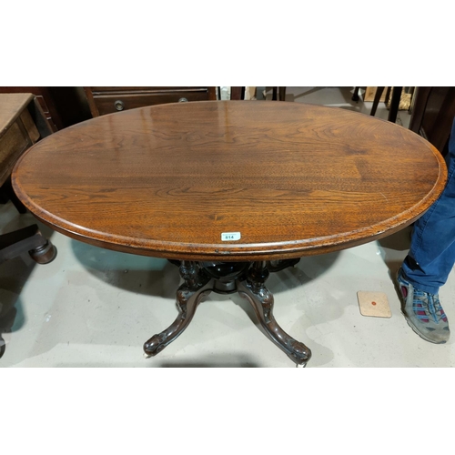 814 - A Victorian walnut centre table with oval top on 4 turned columns, carved splay feet and castors, le... 