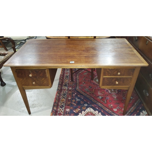 863 - A 1950's mahogany kneehole desk by designer Ian Henderson, with 4 short drawers, on square taqpering... 