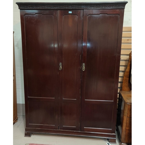 869 - An early 20th century Georgian style triple wardrobe with blind fret cornice, single fitted section ... 