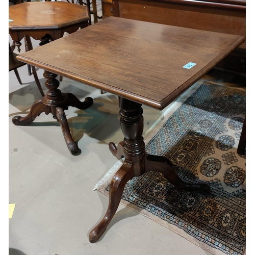 882 - A 19th century mahogany occasional table with rectangular tilt top, on turned column and triple feet