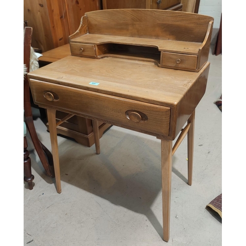 909 - An Ercol light elm and beech writing desk with raised back and frieze drawer