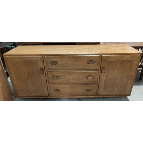 910 - An Ercol light elm sideboard of 2 cupboards and 3 central drawers