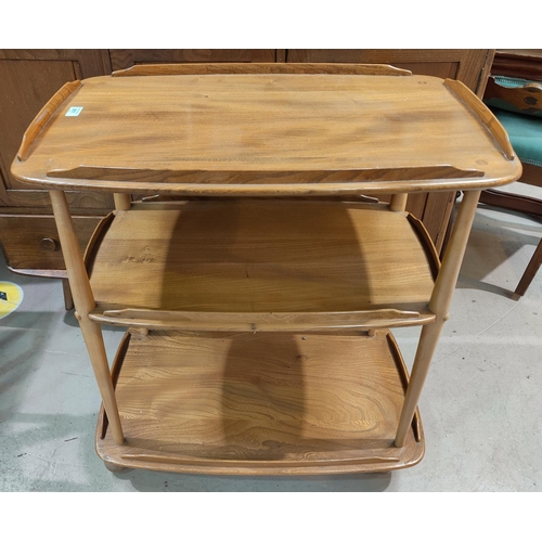 911 - An Ercol light elm 3 height tea trolley