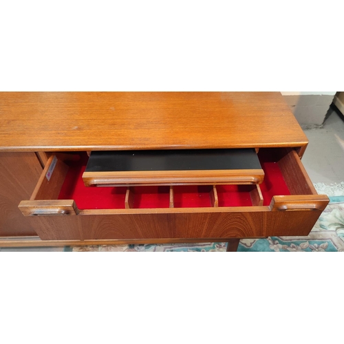 915 - A 1960's lowline sideboard by Mackintosh, comprising 2 sliding drawers, 3 drawers and drinks tray200... 