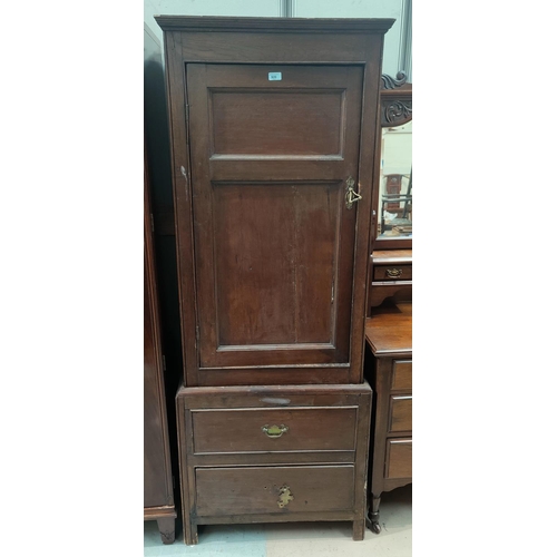 920 - A 19th century narrow full height oak press cupboard with panelled door and 2 drawers under ht.192cm