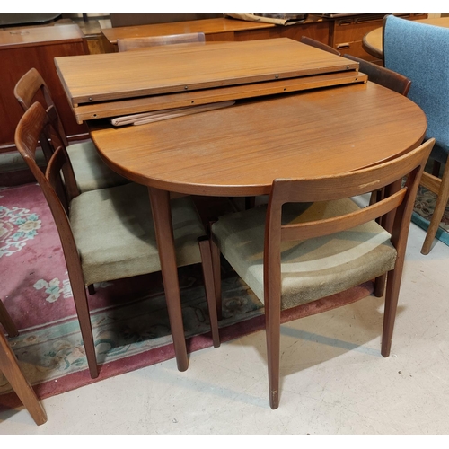 931 - A mid 20th century Troeds Bjarnum extending oval teak dining table with two spare leaves and a set o... 