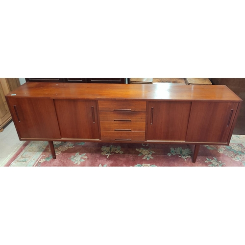 932 - A mid 20th century Troeds Bjarnum long, low, teak sideboard in the manner of Nils Jonsson, having do... 