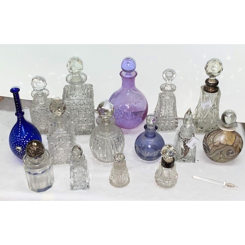 485 - A collection of scent bottles some with silver collars