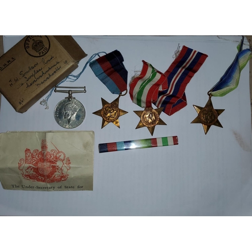 267 - WWII:  a group of 4 medals with dispatch box addressed to Mr W Snelson, the entitlement slip nu... 