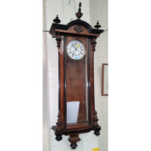 152 - A 19th century Vienna wall clock, with turned finials and mounts, double weight driven striking move... 