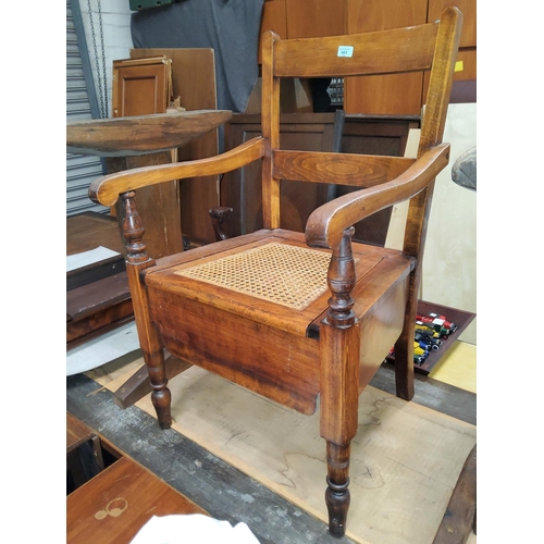 801 - A late 19th/early 20th century commode chair with hinged rush seat