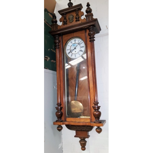 834 - A 19th century Vienna wall clock in walnut case with carved pediment, half turned and reeded side co... 