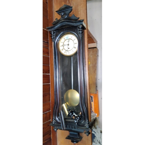 835 - A 19th century Vienna wall clock in ebonised case with raised crest, turned finials and side columns... 