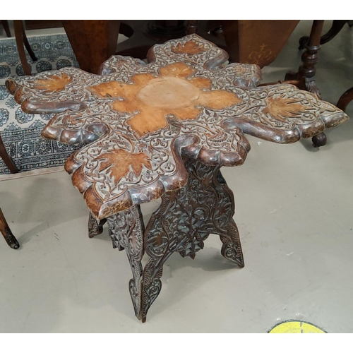 786 - A Chinese carved occasional table with squared top decorated with vines etc