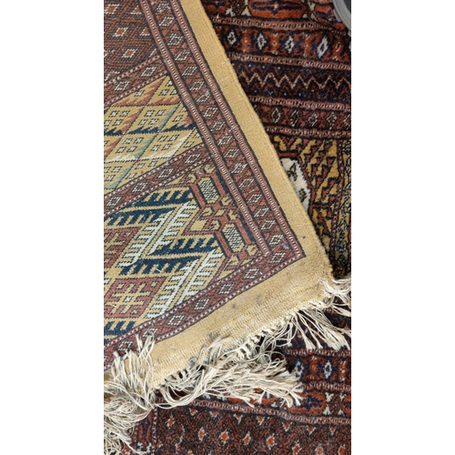 893 - A modern hand knotted Pakistan Bokhara carpet with fawn ground, 340 x 256 cm