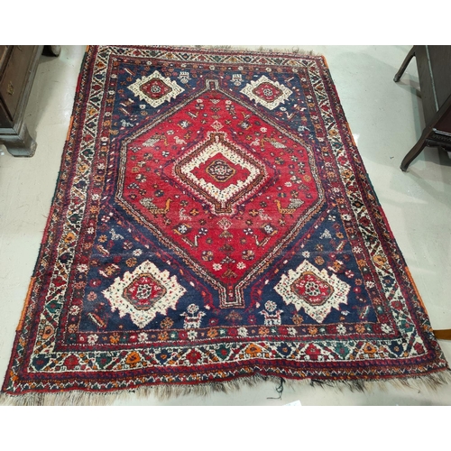 897 - A 20th century hand knotted Persian rug with central medallion on red ground, 180cm x 230cm