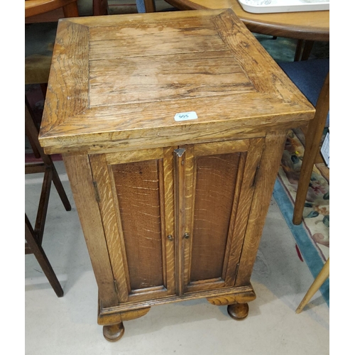 905 - A 1930's oak record cabinet enclosed by twin doors; a wheel back armchair