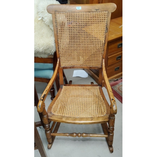 906 - A Victorian stained wood rocking armchair with cane seat and back; a coffee table with rectangular t... 