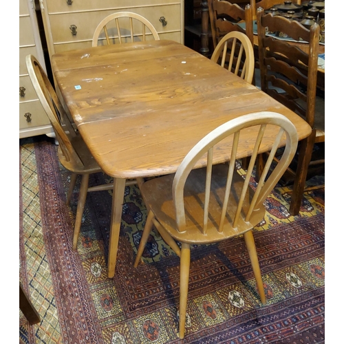 912 - A 1960's Ercol elm and beech dining suite comprising 6 hoop and stick back chairs and table with dro... 