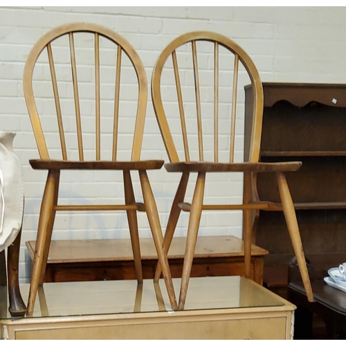 912 - A 1960's Ercol elm and beech dining suite comprising 6 hoop and stick back chairs and table with dro... 