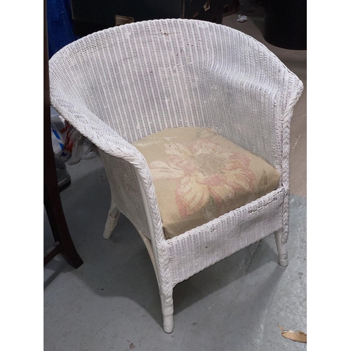 806 - A white Lloyd Loom armchair; a towel rail; an Alibaba basket
