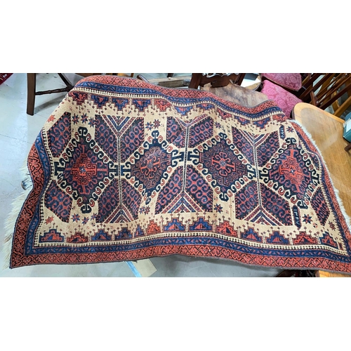 896 - A small 20th century hand knotted carpet with rust ground, signed and dated