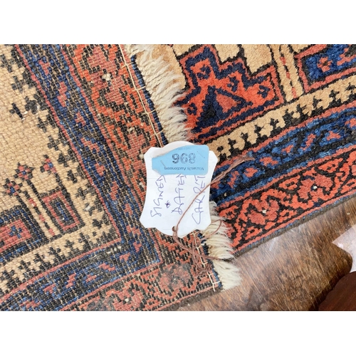 896 - A small 20th century hand knotted carpet with rust ground, signed and dated