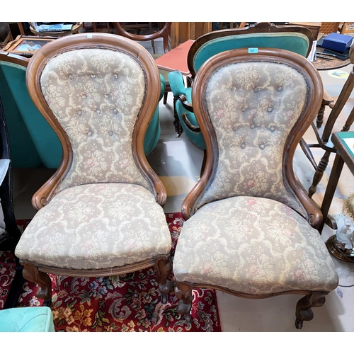 924 - A pair of Victorian mahogany spoon back ladies and gent's armchairs on knurled feet and castors with... 