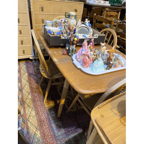 912 - A 1960's Ercol elm and beech dining suite comprising 6 hoop and stick back chairs and table with dro... 