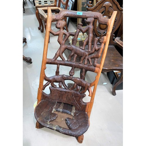 799 - A carved and pierced African tribal folding chair, figures and hippopotami to the back