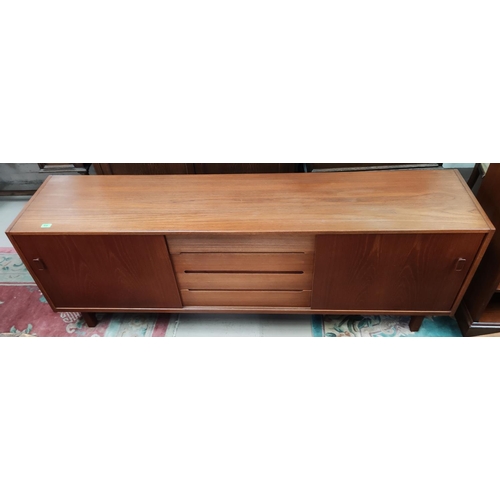 910 - A mid 20th century teak sideboard designed by Nils Jonsson for Troeds with 4 central drawers and 2 s... 