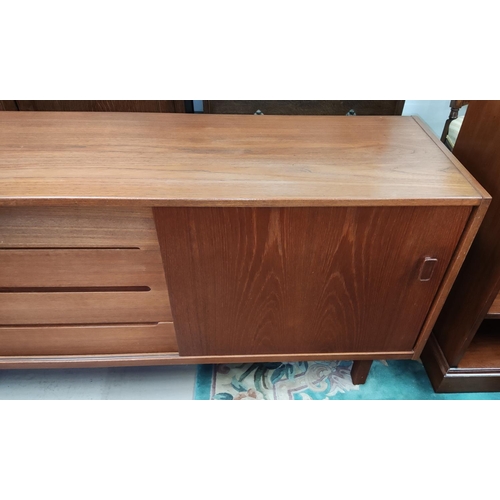 910 - A mid 20th century teak sideboard designed by Nils Jonsson for Troeds with 4 central drawers and 2 s... 