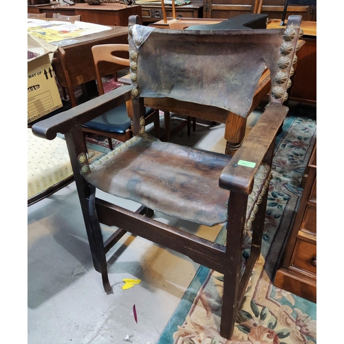 917 - A Cromwellian style captain's armchair with leather studded later seat and back  (some leather ... 