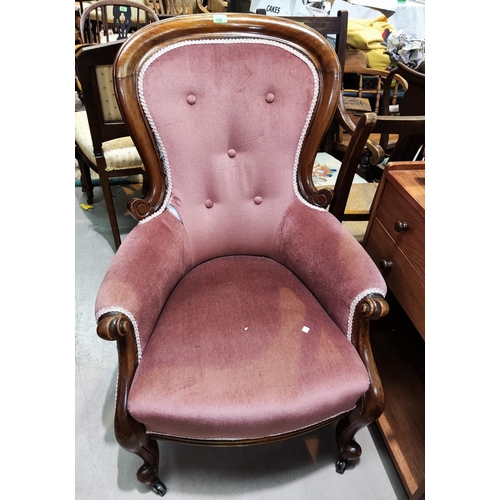 920 - A Victorian mahogany spoon back armchair in buttoned pink dralon