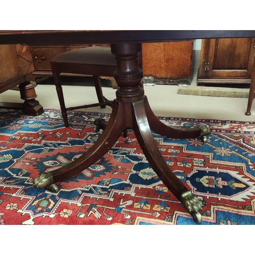 913 - A Regency period mahogany dining table with wide satinwood crossbanding, rounded rectangular tilt to... 