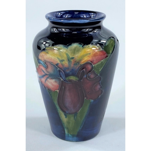 525 - A Moorcroft small baluster vase, orchid pattern on a blue ground, height 9.5 cm