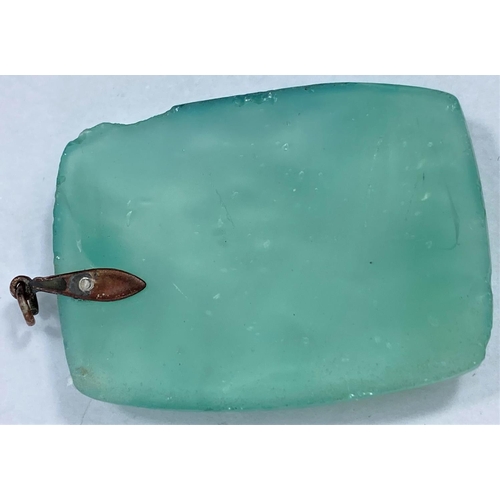 620 - A rectangular turquoise jade coloured pendant in the Chinese manner with relief decoration of flower... 