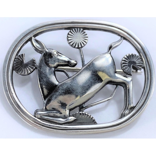 640 - Georg Jensen, an oval silver brooch with deer kneeling amongst foliage, designs by Arno Malinowski, ... 