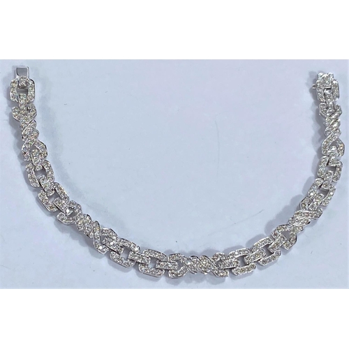 644 - An 18ct hallmarked white gold Art Deco style diamond bracelet , each link encrusted with diamonds, 1... 