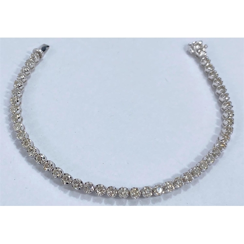 645 - A white metal bracelet, each link set with a brilliant cut diamond, 46 in all, stamped '750' K18, 11... 