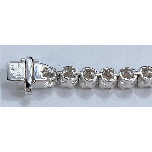 645 - A white metal bracelet, each link set with a brilliant cut diamond, 46 in all, stamped '750' K18, 11... 