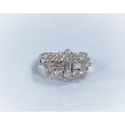 646 - An 18ct hallmarked white gold diamond cluster dress ring set with 3 baguette cut diamonds surrounded... 