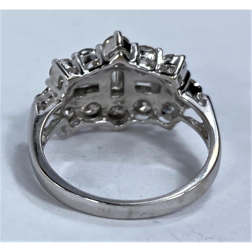 646 - An 18ct hallmarked white gold diamond cluster dress ring set with 3 baguette cut diamonds surrounded... 