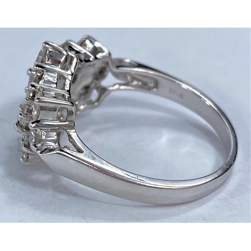 646 - An 18ct hallmarked white gold diamond cluster dress ring set with 3 baguette cut diamonds surrounded... 